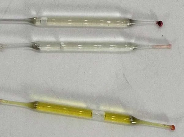 What’s this? Found under a bathroom vanity during remodeling—small glass tubes, 2 inches long, filled with liquid. Any ideas?