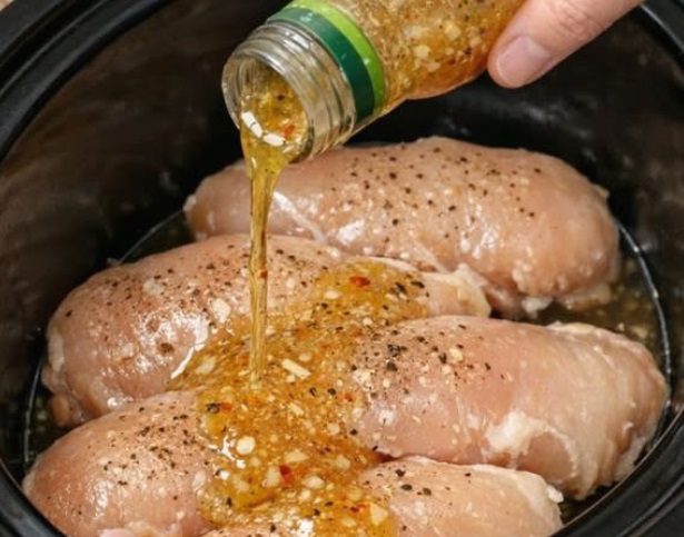 Pour italian dressing over raw chicken breasts, combined with 2 ingredients, into slow cooker for a comforting dinner that is always a yes in my house