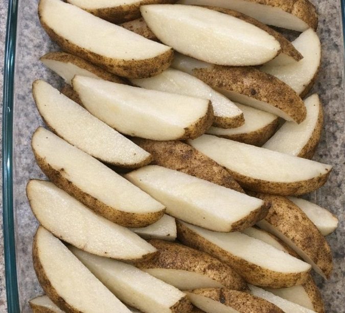 Dump raw unpeeled russet potato wedges in the glass casserole dish and 3 other easy ingredients to get a meal so delicious your family will be begging for more.
